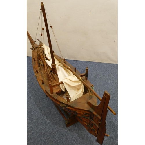 882 - A large model of a sailing boat, with stand, 130cm long