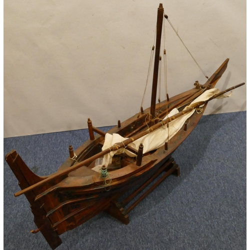 882 - A large model of a sailing boat, with stand, 130cm long