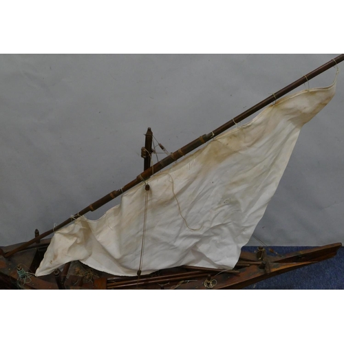 882 - A large model of a sailing boat, with stand, 130cm long