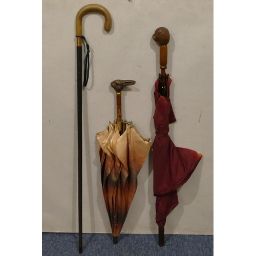 889 - 2 umbrellas with carved wooden handles depicting an otter and rabbit head, both with glass eyes (eye... 