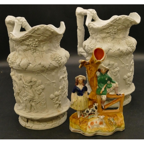 89 - A 19th Century Staffordshire spill vase in the form of a lady and a gentleman seated on a gate with ... 