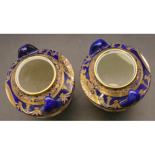 91 - A pair of Noritake small round bulbous thin necked 2-handled vases on royal blue ground with hand pa... 