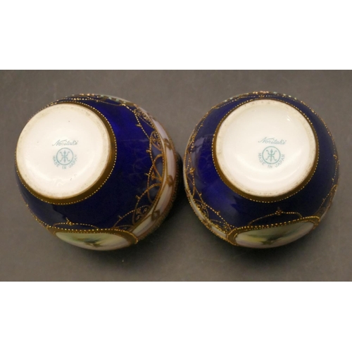 91 - A pair of Noritake small round bulbous thin necked 2-handled vases on royal blue ground with hand pa... 