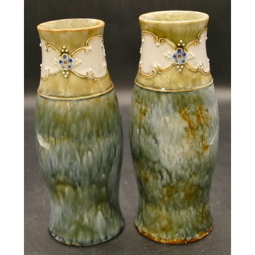 93 - A pair of Royal Doulton glazed earthenware round bulbous thin necked trumpet shaped vases on blue an... 