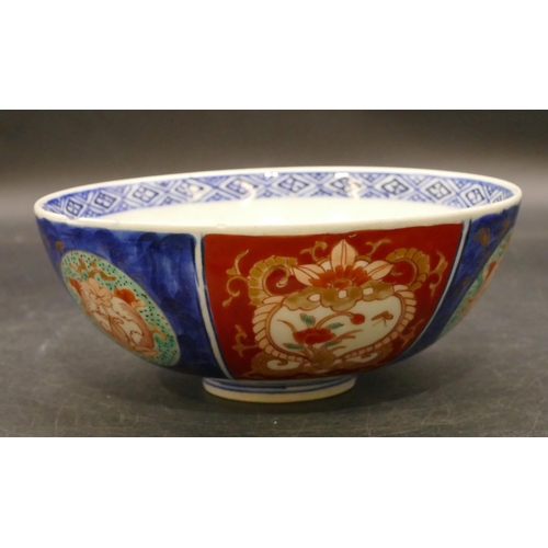 94 - An Imari round bowl on blue and red ground with allover floral, leaf and scroll decoration, 15.3cm d... 