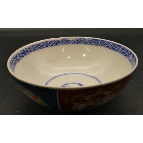 94 - An Imari round bowl on blue and red ground with allover floral, leaf and scroll decoration, 15.3cm d... 