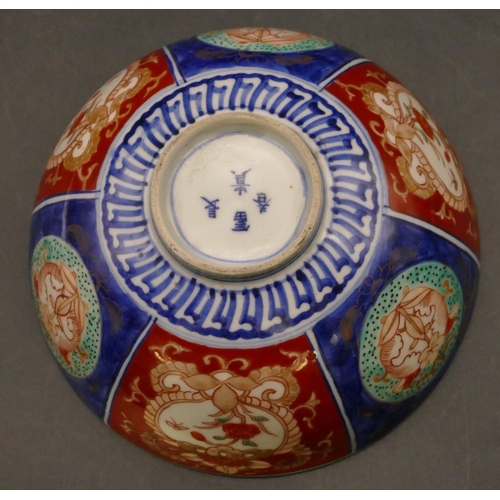 94 - An Imari round bowl on blue and red ground with allover floral, leaf and scroll decoration, 15.3cm d... 