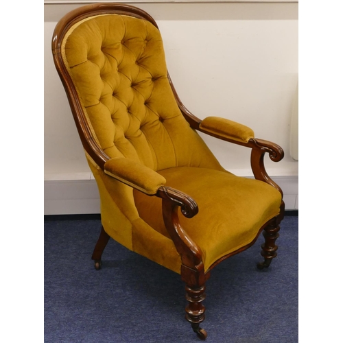 945 - A 19th Century mahogany spoon backed armchair with velvet overstuffed seat, button back and padded a... 