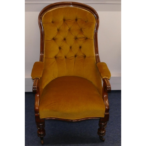 945 - A 19th Century mahogany spoon backed armchair with velvet overstuffed seat, button back and padded a... 