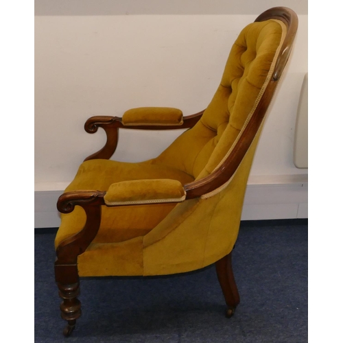 945 - A 19th Century mahogany spoon backed armchair with velvet overstuffed seat, button back and padded a... 