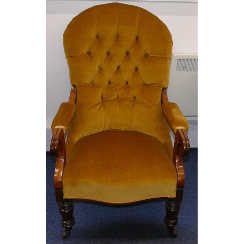 946 - A 19th Century mahogany spoon back armchair with velvet overstuffed seat, button back and padded arm... 