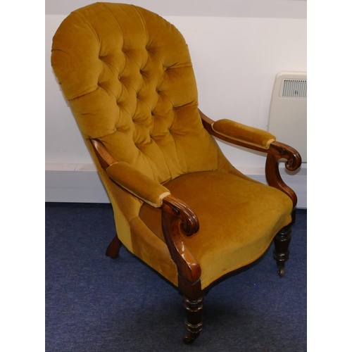 946 - A 19th Century mahogany spoon back armchair with velvet overstuffed seat, button back and padded arm... 