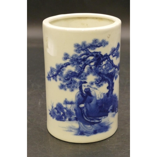 95 - An Oriental cylindrical brush pot on blue and white ground with figure and tree decoration, 12.5cm h... 