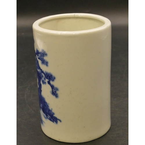 95 - An Oriental cylindrical brush pot on blue and white ground with figure and tree decoration, 12.5cm h... 