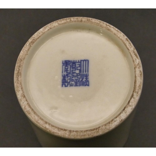 95 - An Oriental cylindrical brush pot on blue and white ground with figure and tree decoration, 12.5cm h... 