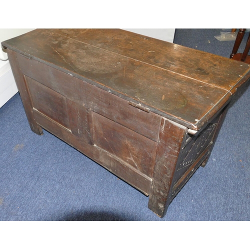 951 - An 18th Century oak dower chest with carved double panelled front, hinged lid on stile feet, 101cm w... 