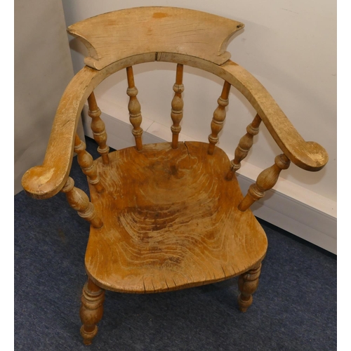 956 - An elm Captain's chair with spindle back, solid seat on round turned legs