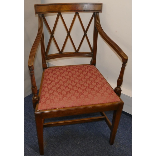 957 - A mahogany carving chair with X shaped back, reeded arms, cream dropping seat on square tapering leg... 