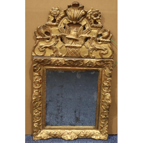 973 - An 19th Century gilt wood hanging wall mirror with carved and pierced bird, floral, leaf and scroll ... 