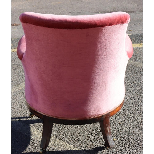 975 - A 19th Century mahogany tub chair with pink velvet overstuffed seat, button back and arms, raised ca... 