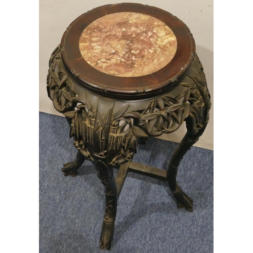 982 - An Oriental hardwood round bulbous shaped jardinière stand with marble top, carved and pierced friez... 