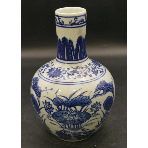 99 - An Oriental round bulbous thin necked blue and white vase with bird, lily and floral decoration, 22c... 