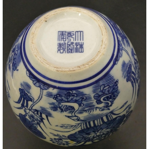 99 - An Oriental round bulbous thin necked blue and white vase with bird, lily and floral decoration, 22c... 