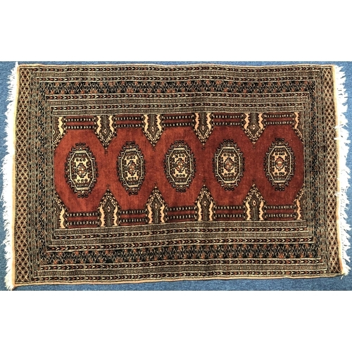 830 - A modern Persian rug on red ground with 4 centre elephant foot medallions, 187cm x 126cm