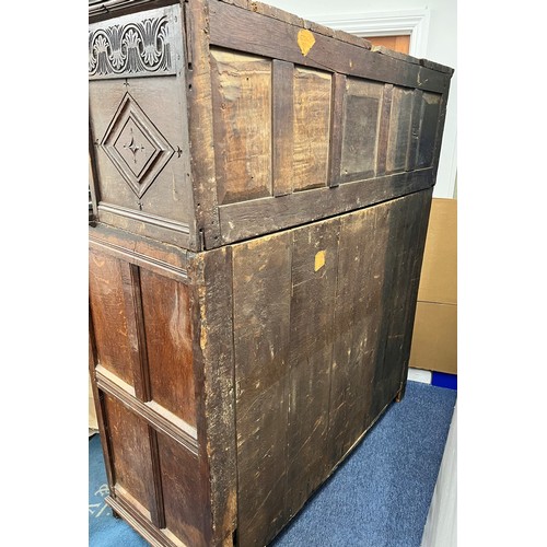 984 - An 18th century oak court cupboard, centre panel flanked by 2 carved panelled doors above 2 large ca... 