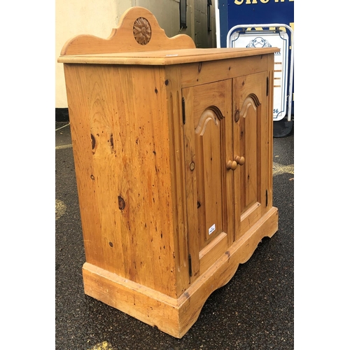 8020 - A pine low cupboard with 2 panel doors, wood knob handles, 76cm wide, 42cm deep, 82cm high. This Lot... 