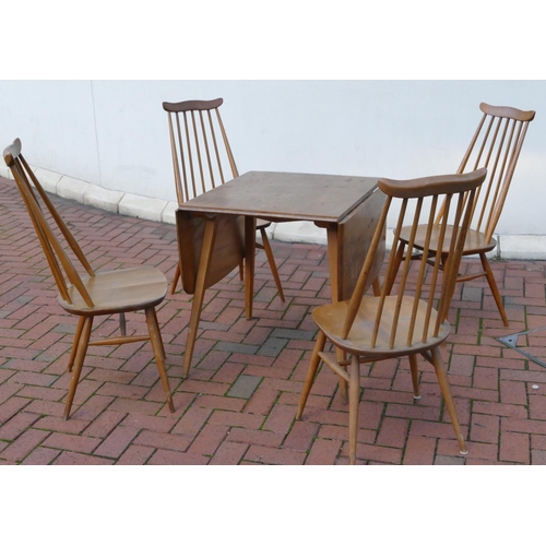 8071 - An Ercol elm dining suite with drop leaf table, 73cm deep, 138.5cm wide, 71cm high and 4 stick back ... 