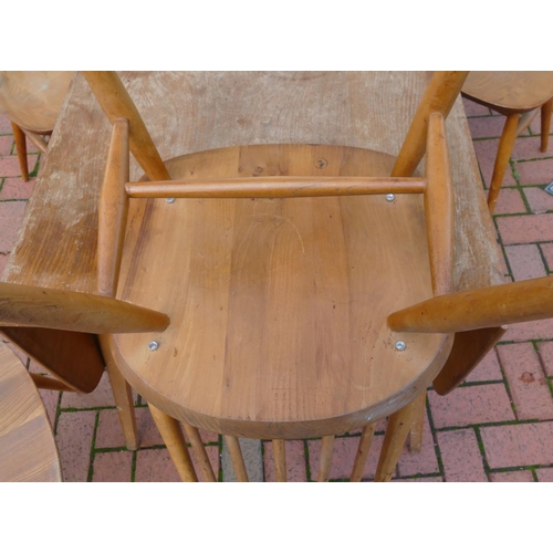 8071 - An Ercol elm dining suite with drop leaf table, 73cm deep, 138.5cm wide, 71cm high and 4 stick back ... 