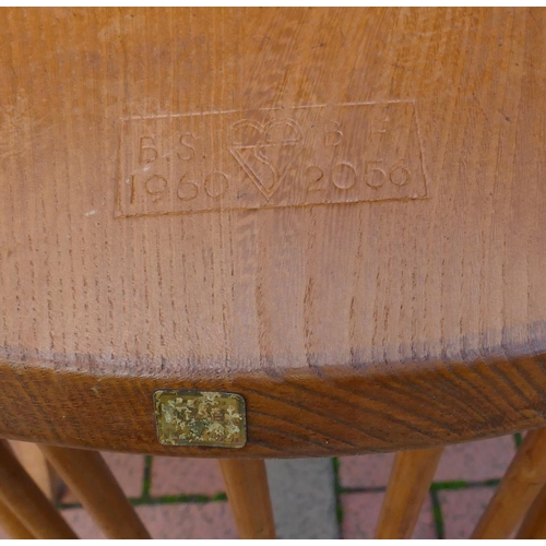 8071 - An Ercol elm dining suite with drop leaf table, 73cm deep, 138.5cm wide, 71cm high and 4 stick back ... 