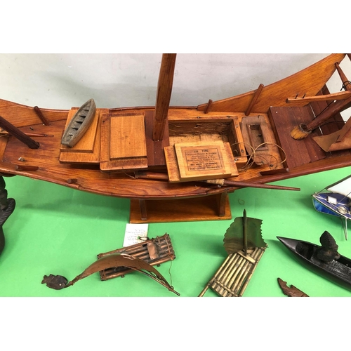 8095 - A wooden model of a Junk boat on stand, 2 model brass sailing rafts and 4 other model boats.