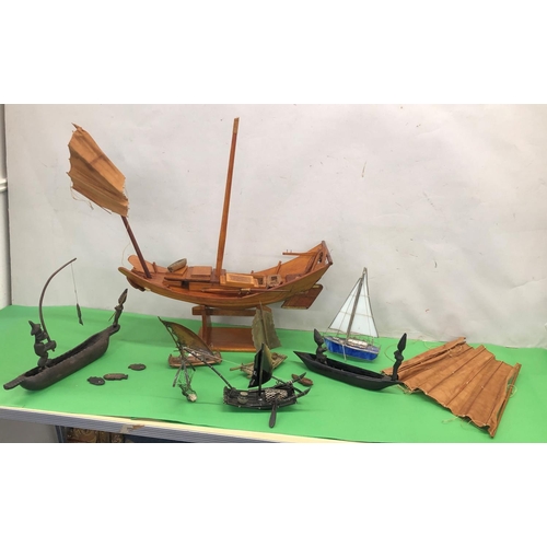 8095 - A wooden model of a Junk boat on stand, 2 model brass sailing rafts and 4 other model boats.