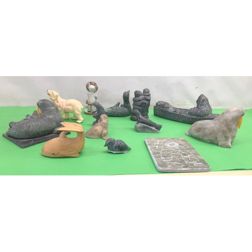 8101 - A quantity of soapstone Eskimo art figures, a plaque depicting an Eskimo fishing and various other f... 