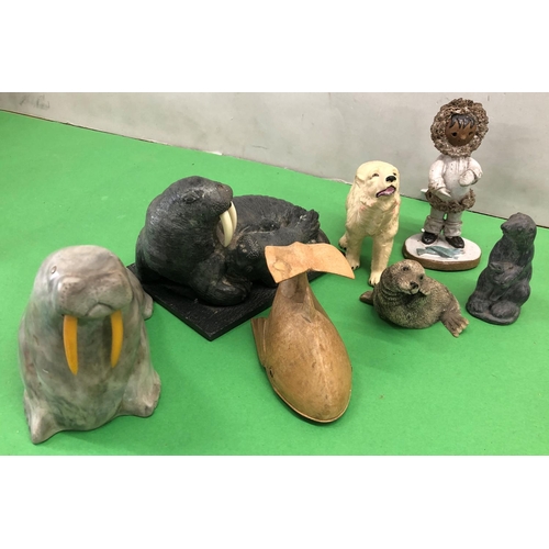 8101 - A quantity of soapstone Eskimo art figures, a plaque depicting an Eskimo fishing and various other f... 