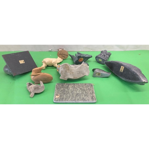 8101 - A quantity of soapstone Eskimo art figures, a plaque depicting an Eskimo fishing and various other f... 