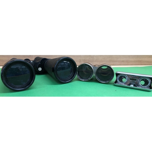 8113 - A pair of brown leather binoculars 17cm high overall, a pair of Prinz Powerview 20x60 binoculars and... 