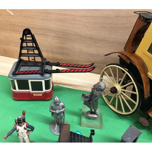 8136 - A mixed quantity of model carriages, ski lift, model soldiers, novelty pencil sharpeners etc.