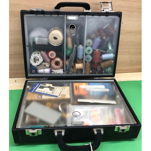 8142 - A quantity of sewing materials, threads, needles etc in hard carrying case.