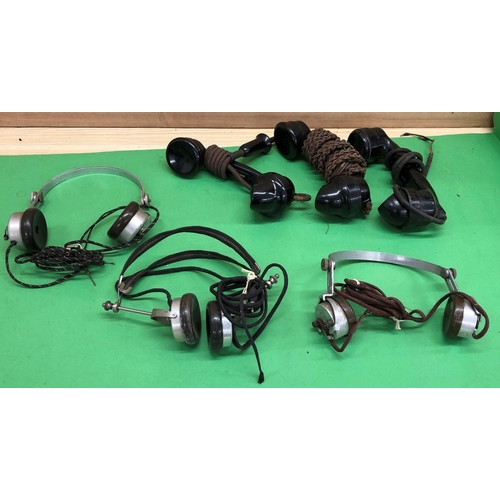 8159 - Various vintage telephone handsets and headphones.