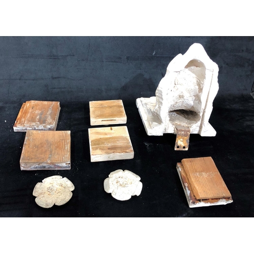 8169 - A plaster wall bracket and 7 plaster moulds.