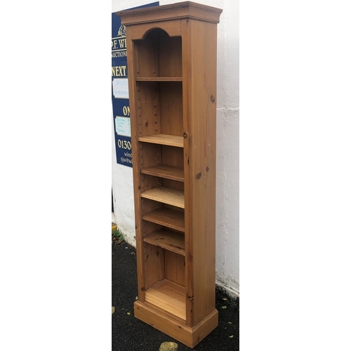 8003 - A reproduction pine tall narrow open front bookcase with various adjustable shelves, 54cm wide, 29cm... 