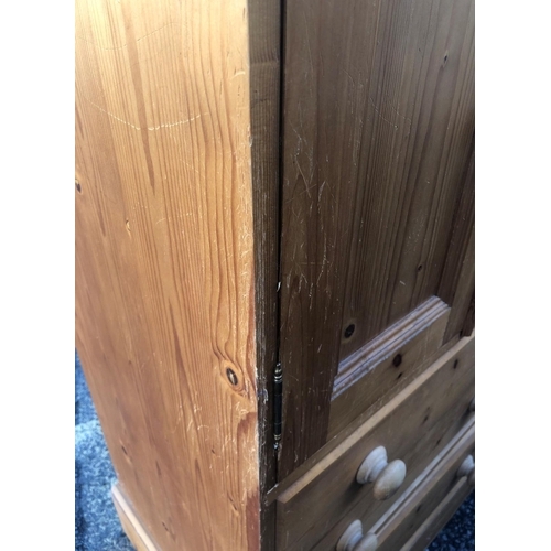 8008 - A pine narrow cupboard with 2 panel doors and 3 drawers below, wood knob handles, 66cm wide, 48cm de... 