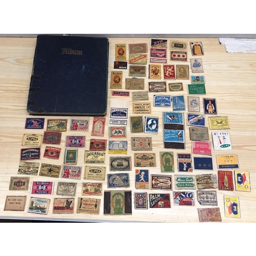 8064 - An album of match box covers and a quantity of loose matchbox covers.