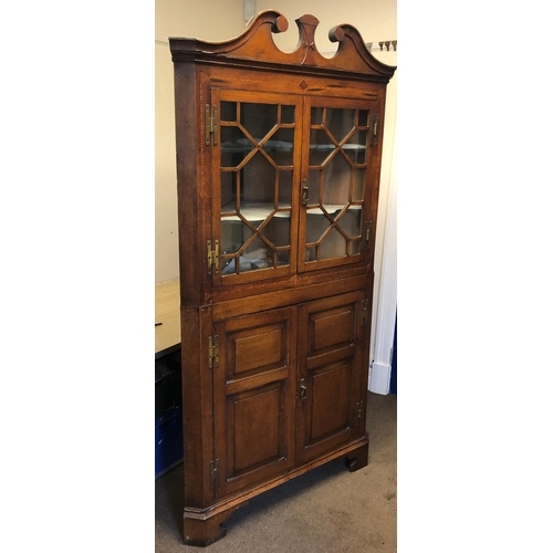 8178 - A Georgian oak 2-sectioned corner cupboard with allover inlaid Herringbone and stringing, swan neck ... 