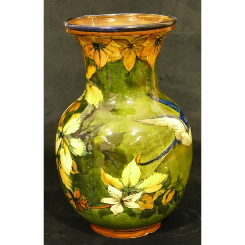 111 - A 19th Century glazed earthenware round bulbous thin necked trumped shaped vase on green and yellow ... 