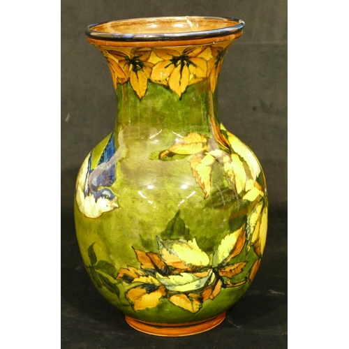 111 - A 19th Century glazed earthenware round bulbous thin necked trumped shaped vase on green and yellow ... 