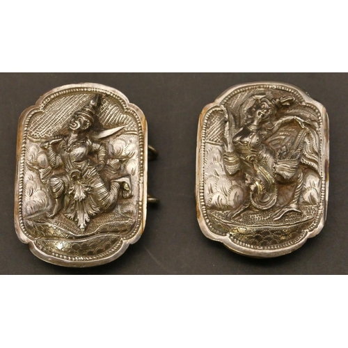 510 - An Eastern silver 2-piece buckle with raised figure motifs, 7.7cm wide overall, 38.5 grams